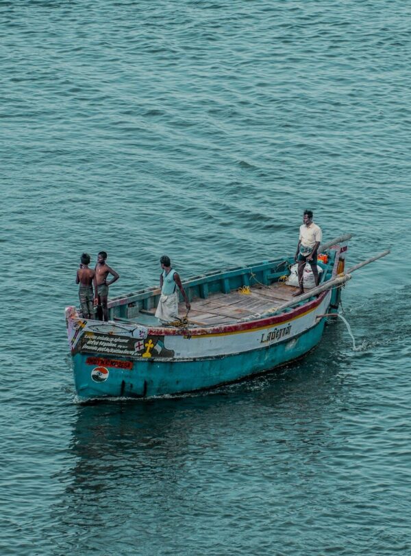 2 men and woman riding on boat on sea during daytime