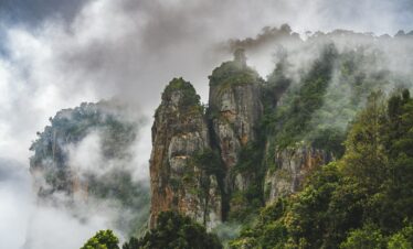 a mountain covered in fog and clouds