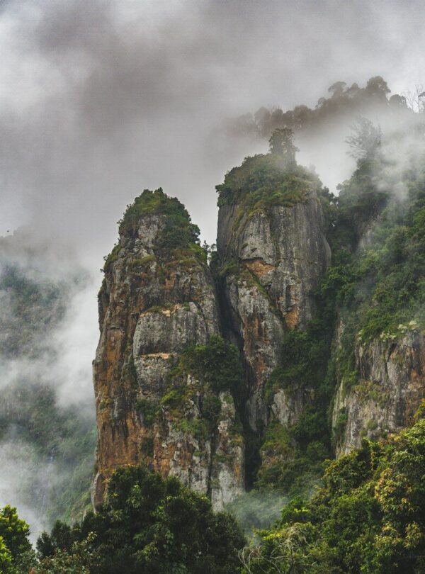 a mountain covered in fog and clouds