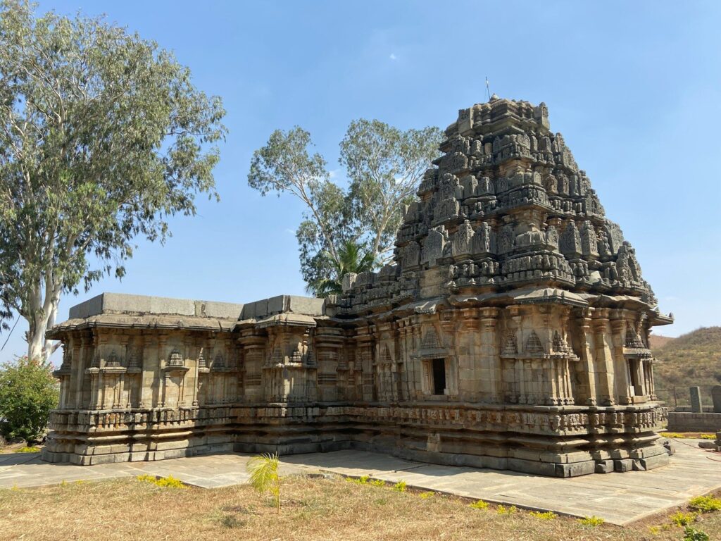 a large stone structure with a tree in the background