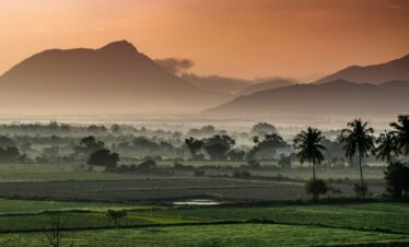 green grass field near mountain during daytime