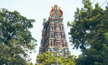 a tall tower with a statue on top of it