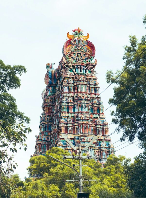 a tall tower with a statue on top of it