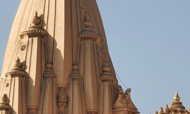 A tall building with a cross on top of it