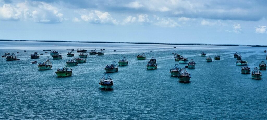 a group of boats floating on top of a large body of water