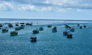 a group of boats floating on top of a large body of water