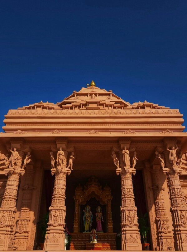a very tall building with statues on it's sides