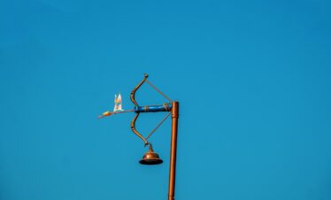 A street light with a blue sky in the background