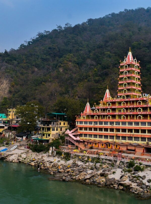 a very tall building sitting on the side of a river