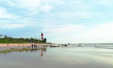 a group of people walking on a beach